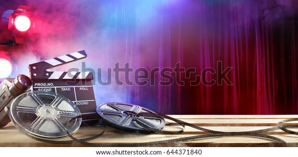 Film movie Background - Clapperboard And Film\
Reels In Theater\
