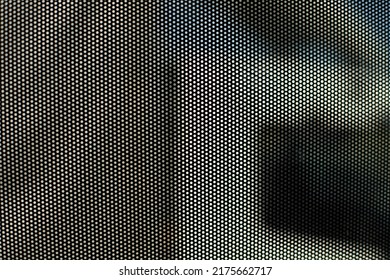 Film On Glass Of Mesh Texture. Advertising Film From Inside Interior Of Bus. Fine Grid And Blurry Background.