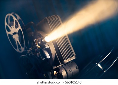 film projector on a wooden background with dramatic lighting and selective focus - Shutterstock ID 560105143