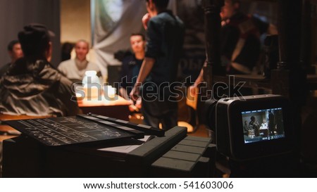 Film set - director, cinematographer and actors working on the cinema, wide angle