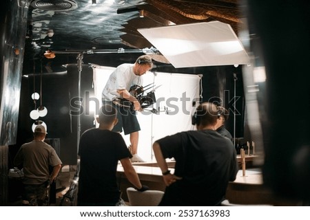 Film set, monitors and modern shooting equipment. Film crew, lighting devices, monitors, playbacks - filming equipment and a team of specialists in filming movies, advertising and TV series