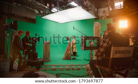 Film Studio Set: Shooting Green Screen Scene with Two Talented Actors Wearing Renaissance Clothes Talking, Embraces. Period Drama Movie Backstage