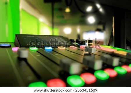 	
Film video studio with cameras, mixing console, spotlights and a round green screen background for chrominance technology and post-production technology at a film production company.