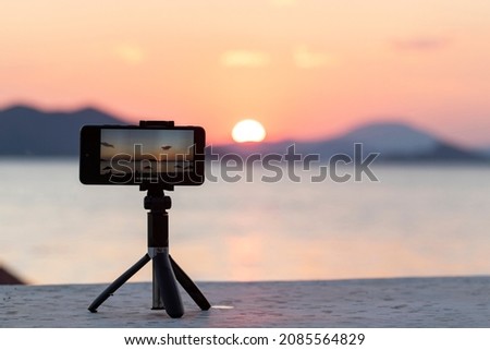 Filming by phone on the tripod at sunset. Seascape at sunset. Fethiye, Turkey