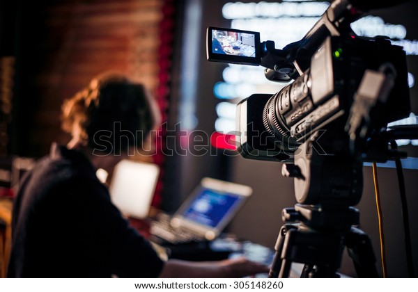 Filming creative video footage with professional\
video camera during the\
night