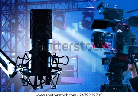 Filming equipment. Professional video camera. Condenser microphone. Camera for online broadcasting. Speaker microphone in spotlight. Camera for filming concert. Microphone for event host