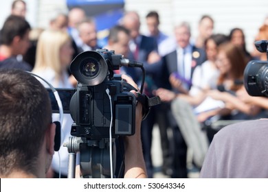 Filming an media event with a video camera. Press conference. - Shutterstock ID 530643346