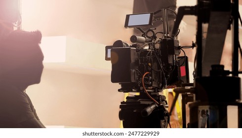 Filmmaker crew team with professional cinema equipment and video camera on the set. Film director and crew making commercial content advertising in studio. Technique of modern filming and advertising.