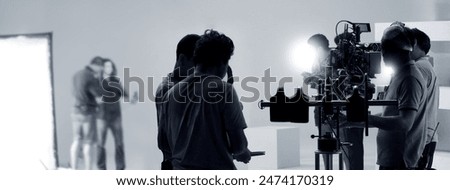 Filmmaker crew team with professional cinema equipment and video camera on the set. Film director and crew making commercial content advertising in studio. Technique of modern filming and advertising.