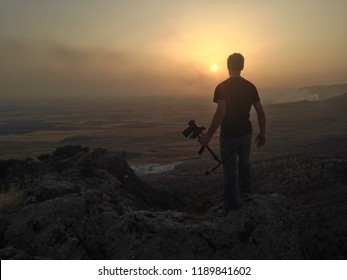 Filmmaker overlooking valley in norther Iraq at sunset
