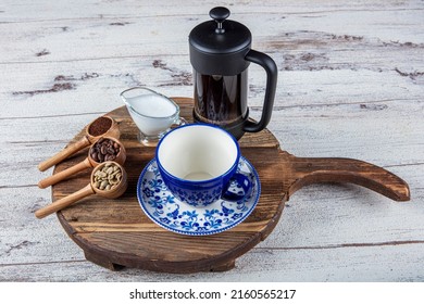 Filter coffee. The steam from Pouring coffee into cup. A scattering of coffee beans with a cup of coffee. wooden presentation, hot food and healthy meal concept.