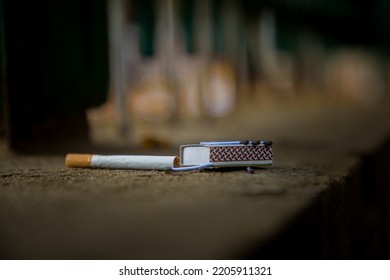 Filtered Cigarette And Matchbox On The Street.  