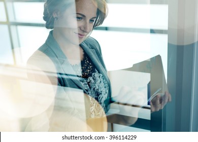 Filtered Portrait Of An Executive Business Woman Writing On A Glass Wall At Sunset