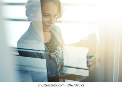 Filtered Portrait Of An Executive Business Woman Writing On A Glass Wall At Sunset