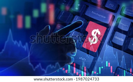 Fin tech concept. Hand pressing dollar key as symbol of financial technologies. Fin tech software. Dollar symbol keyboard and double exposure investment charts. Use of financial technology.