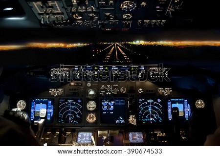 Final approach at night - landing of a jet airliner, view from the cockpit