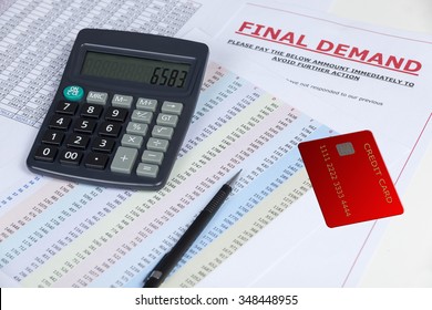 Final Demand Letter On A Desk With A Credit Card And A Calculator And Some Statements