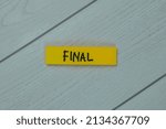 Final write on sticky notes isolated on Wooden Table.