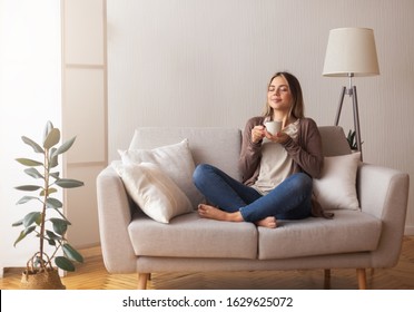 Finally Coffee. Young Coffee Lover Sniffing Hot Drink At Cozy Home Interior, Empty Space