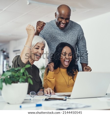 Finally were getting somewhere. Cropped shot of a group of cheerful businesspeople looking at a laptop screen together while cheering in excitement inside of the office.
