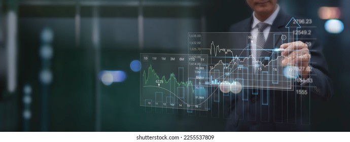 Finance analyst analyzing stock market report with financial data, economic graph growth chart on virtual screen with dark background,  Business growth, planing, strategy, finance and investment  - Shutterstock ID 2255537809