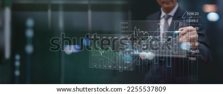 Finance analyst analyzing stock market report with financial data, economic graph growth chart on virtual screen with dark background,  Business growth, planing, strategy, finance and investment 
