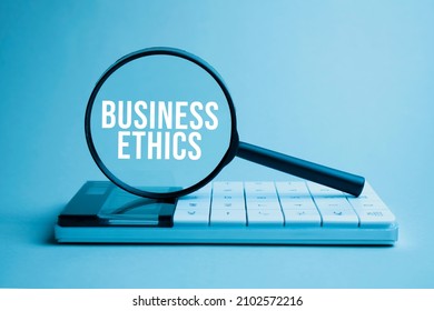 Finance and business concept. On a white background lies a calculator and a magnifying glass with the inscription - Business Ethics