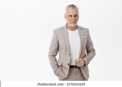 Finance, Business And Success Concept. Portrait Of Rich Senior Male Entrepreneur In Elegant Suit With Grey Hair And Beard Checking Outfit And Smiling Delighted At Camera Attending Party With Investors