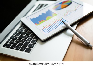 Finance Chart on tablet pc with laptop computer