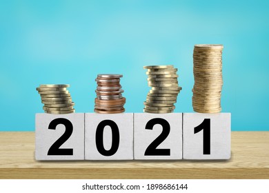 Finance coins stack with 2021 wood cube.  
New year 2021 financial and saving money concept. - Shutterstock ID 1898686144