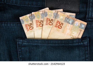 Finance concept. Brazilian fifty reais banknotes in the pocket of jeans.