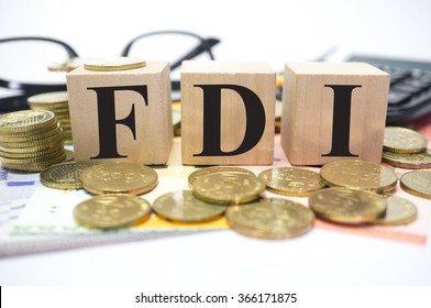 Finance Concept With Stack Of Coins, FDI Or Foreign Direct Investment Written