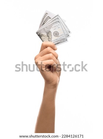 finance, currency and people concept - close up of hand holding 100 dollar banknotes over white background