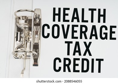 Finance And Economics Concept. In The Folder Under A Paper Clip There Is A White Sheet With The Inscription - Health Coverage Tax Credit