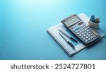 Finance equipment like calculator, pen, book and money with blue blank space. Accountant equipment background for business background