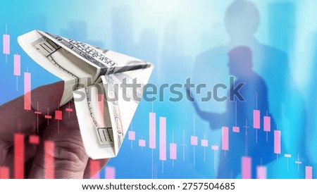 Finance, Investment risk. Hand holds a dollar banknote folded as a paper airplane with stock charts overlay, symbolizing volatile markets, speculative trading and capital outflow.