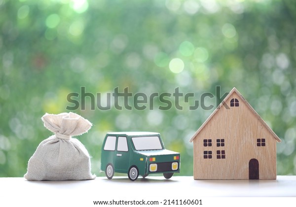 Finance, Model house with the car and\
money bag on natural green background,Business investment and save\
money for prepare in future\
concept,Inflation