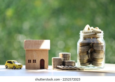 Finance, Model house and coins money in glass bottle on nature green background, Saving money for new home concept - Shutterstock ID 2252572023