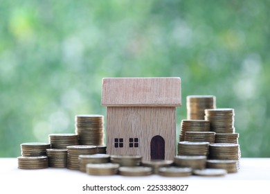 Finance, Model house and Growing stack of coins money on nature green background, Saving money for new home concept - Shutterstock ID 2253338027