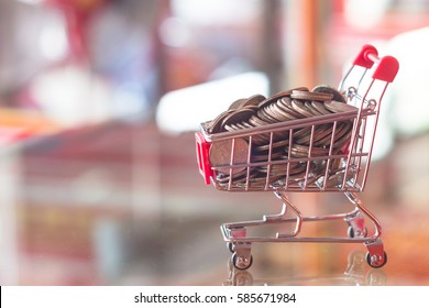 Finance and money concept mini shopping cart red blurry background