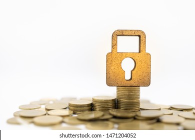 Finance, Money, Security And Saving Concept. Close Up Of Wooden Master Key Lock Icon On Top Of Stack Of Gold Coins On White Background And Copy Space.