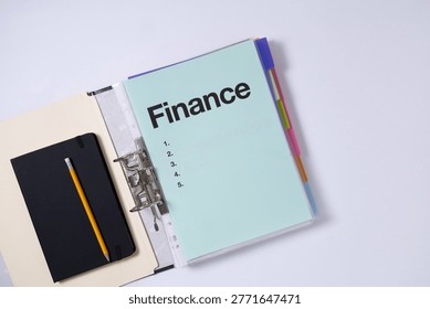 Finance planning concept with binder, notebook and pencil, representing budgeting, organization and financial management.