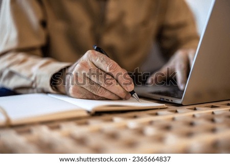Finance, retirement and old man with paperwork, laptop and budget plan, checking investment and taxes. Mortgage, insurance document and online pension savings review, senior man with debt in home.