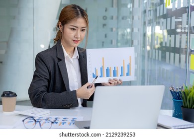 Finance Staff Holding Financial Graph Documents Presented To Executives And Attendees Via Videoconference, Meeting To Summarize The Operations Of All Departments. Videoconferencing Concept.