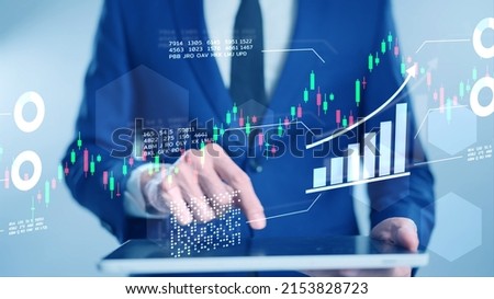 Finance stock exchange market trading graph chart, business investor using tablet computer analyzing financial planning and markets data Enterprise company debt asset income growth
