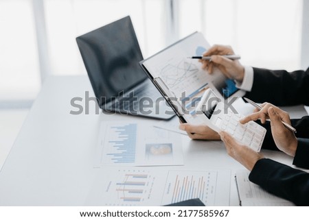 Finance workers are working together to prepare company financial documents for the meeting with management, together they are checking the accuracy of the information. Financial concept.