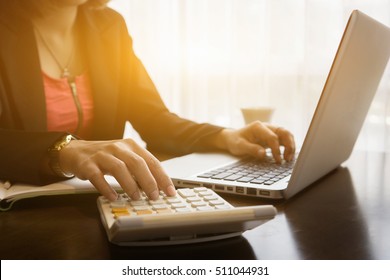 finance,accounting,Businesswomen analyzing investment charts with calculator laptop calculate technology in office, marketing business analysis  data concept,selective focus,vintage color - Shutterstock ID 511044931