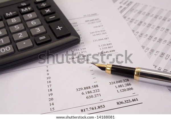 Finances and\
balances with pen and\
calculator