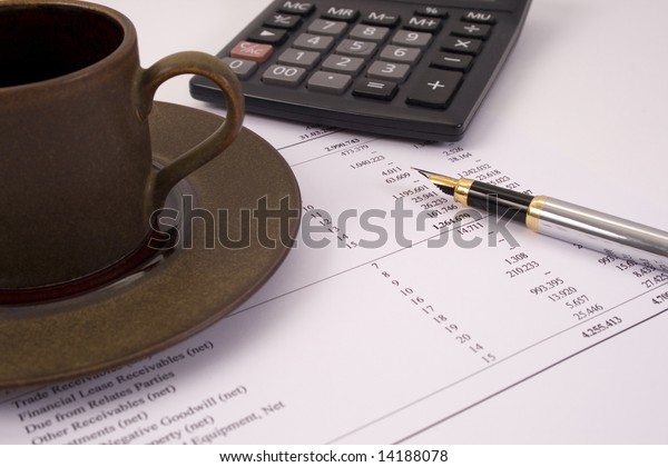Finances and\
balances with pen, coffee and\
calculator