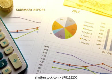 Finances graph summary report,Calculators and coins on paper work in the office. Finance concept.